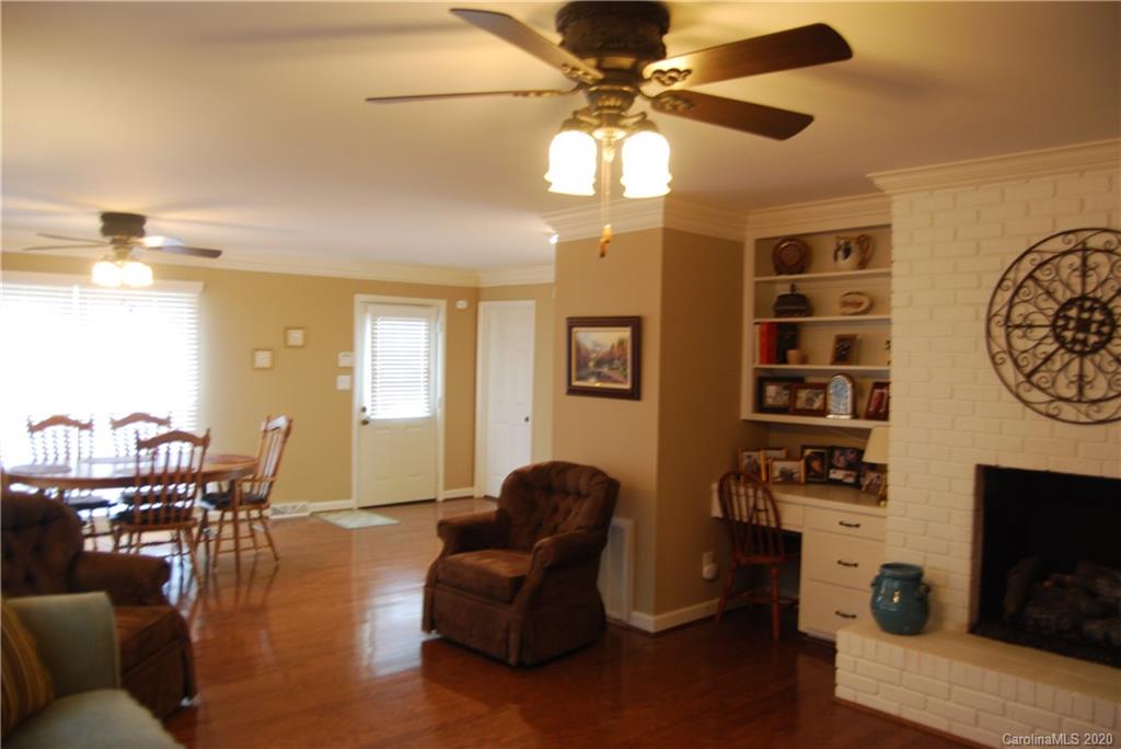 2716 Stack Road Monroe, NC 28112 - Photo 33 of 42 a living room with furniture a chandelier and a fireplace