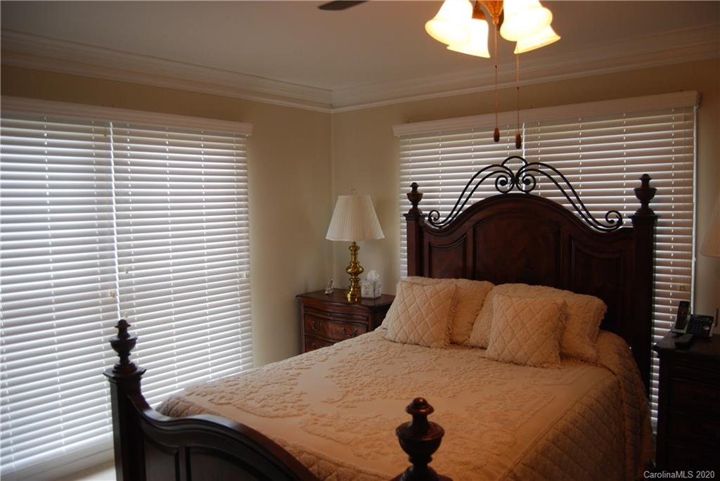 2716 Stack Road Monroe, NC 28112 - Photo 37 of 42 a bedroom with a bed and a chandelier