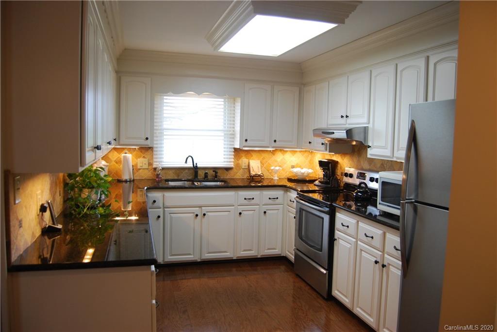 2716 Stack Road Monroe, NC 28112 - Photo 10 of 42 a kitchen with stainless steel appliances granite countertop a sink stove and refrigerator