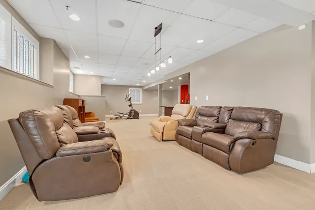 a living room with furniture a window and gym equipment