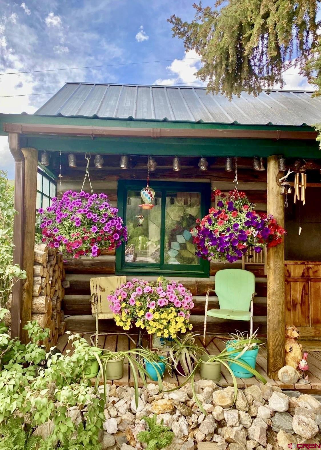 8639 County Road 76 Ohio City, CO 81237 - Photo 24 of 26 a front view of a house with a yard and fountain