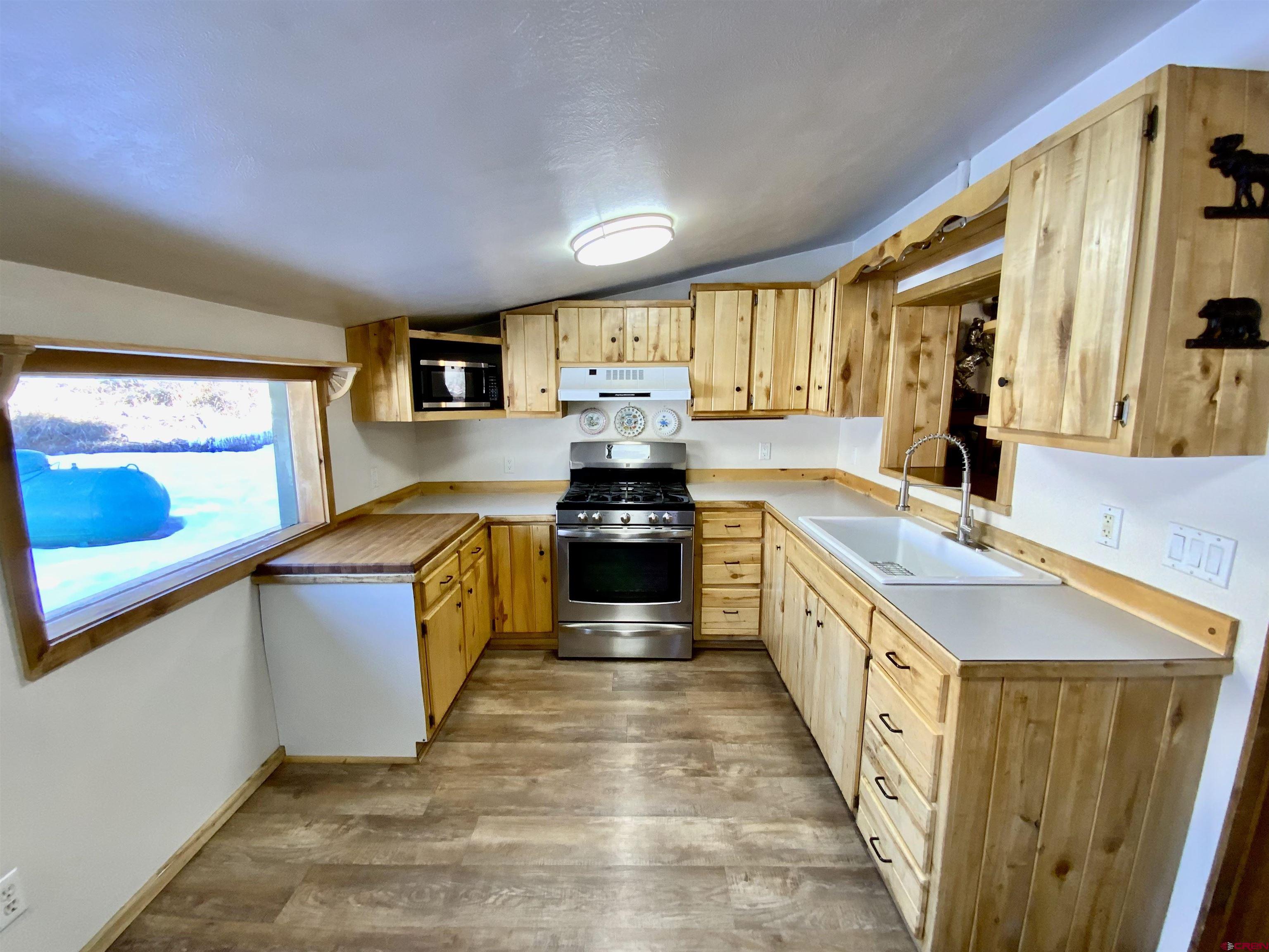 8639 County Road 76 Ohio City, CO 81237 - Photo 8 of 26 a large kitchen with stainless steel appliances granite countertop a stove and a sink