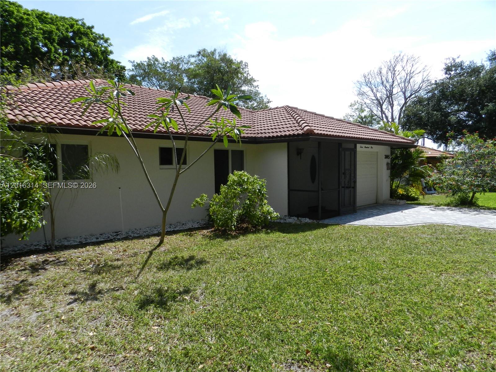 305 Northwest 42nd Street Boca Raton, FL 33431 - Photo 3 of 31 a view of a house with a yard