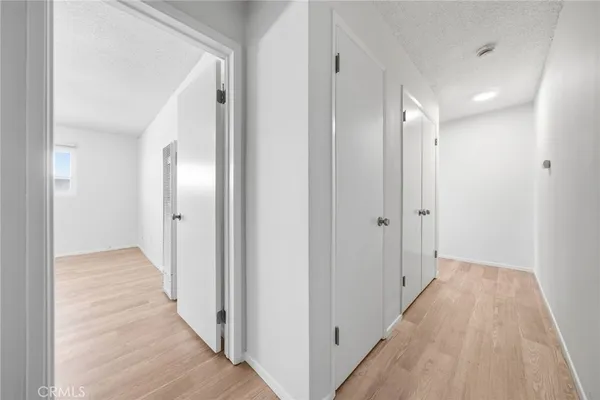a view of a hallway with wooden floor