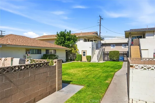 a front view of house with a garden