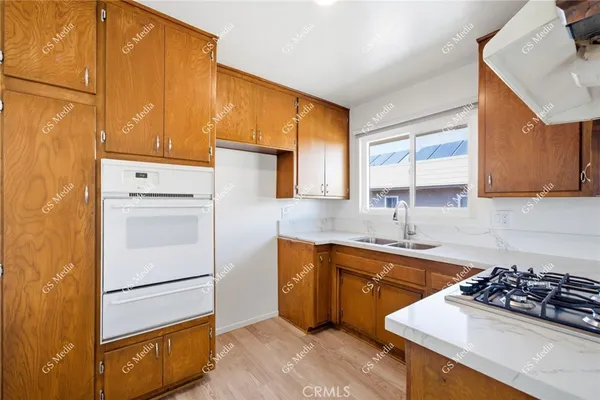 a kitchen with a refrigerator sink and stove top oven