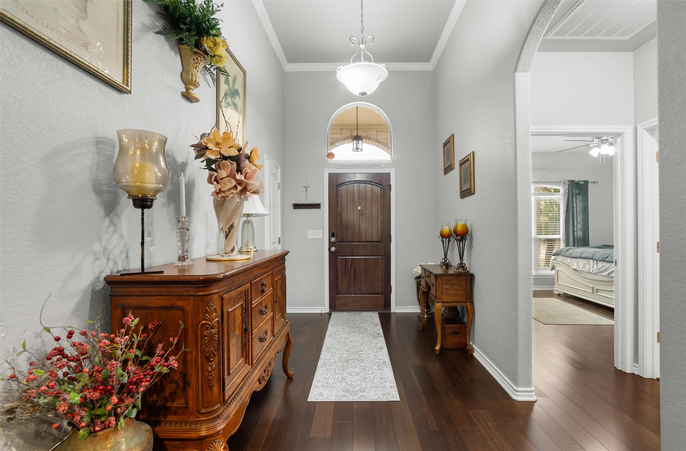16017 Toby Court Temple, TX 76502 - Photo 3 of 33 Entrance foyer featuring arched walkways, dark wood-type flooring, ornamental molding, and a ceiling fan