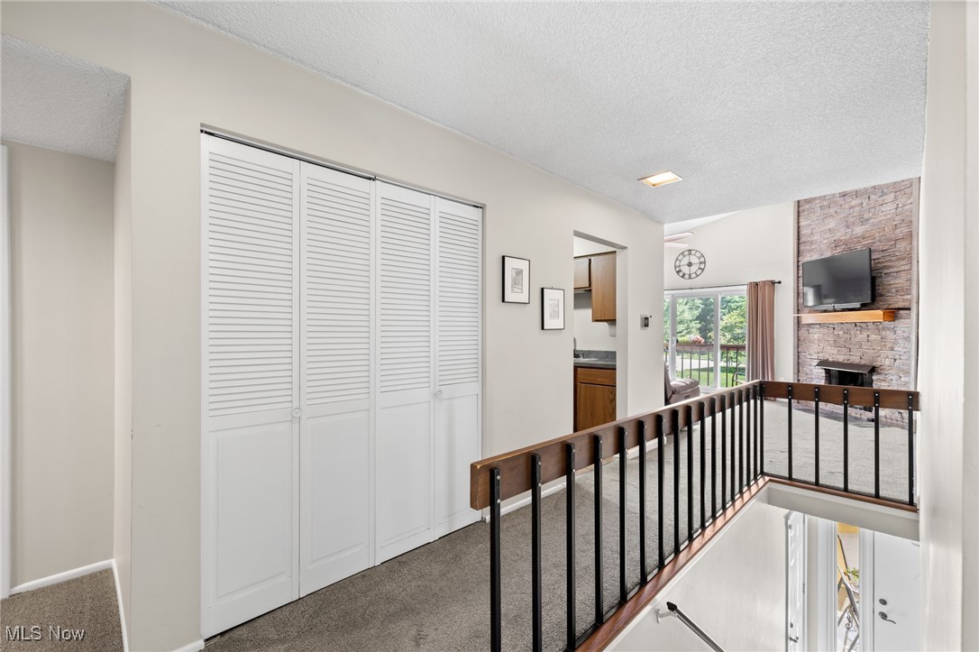 889 Hampton Ridge Drive Akron, OH 44313 - Photo 9 of 38 Hall with a textured ceiling and carpet floors