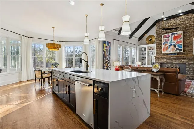 a kitchen with stainless steel appliances granite countertop a sink and stove
