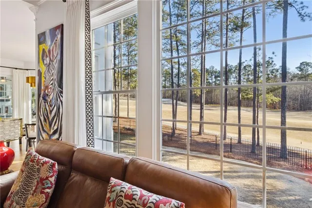 a bedroom with a bed a couch and a window