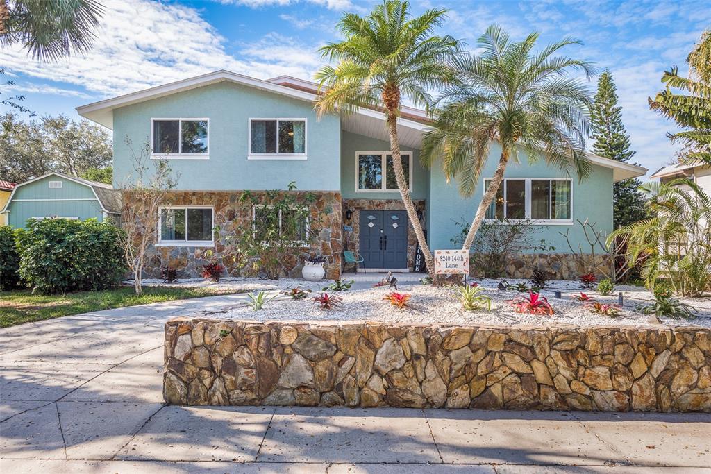 a view of house with outdoor space and garden