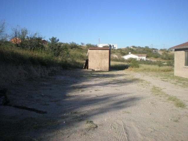 982 Paseo Guebabi Rio Rico, AZ 85648 - Photo 3 of 9 a view of a dry yard with wooden fence