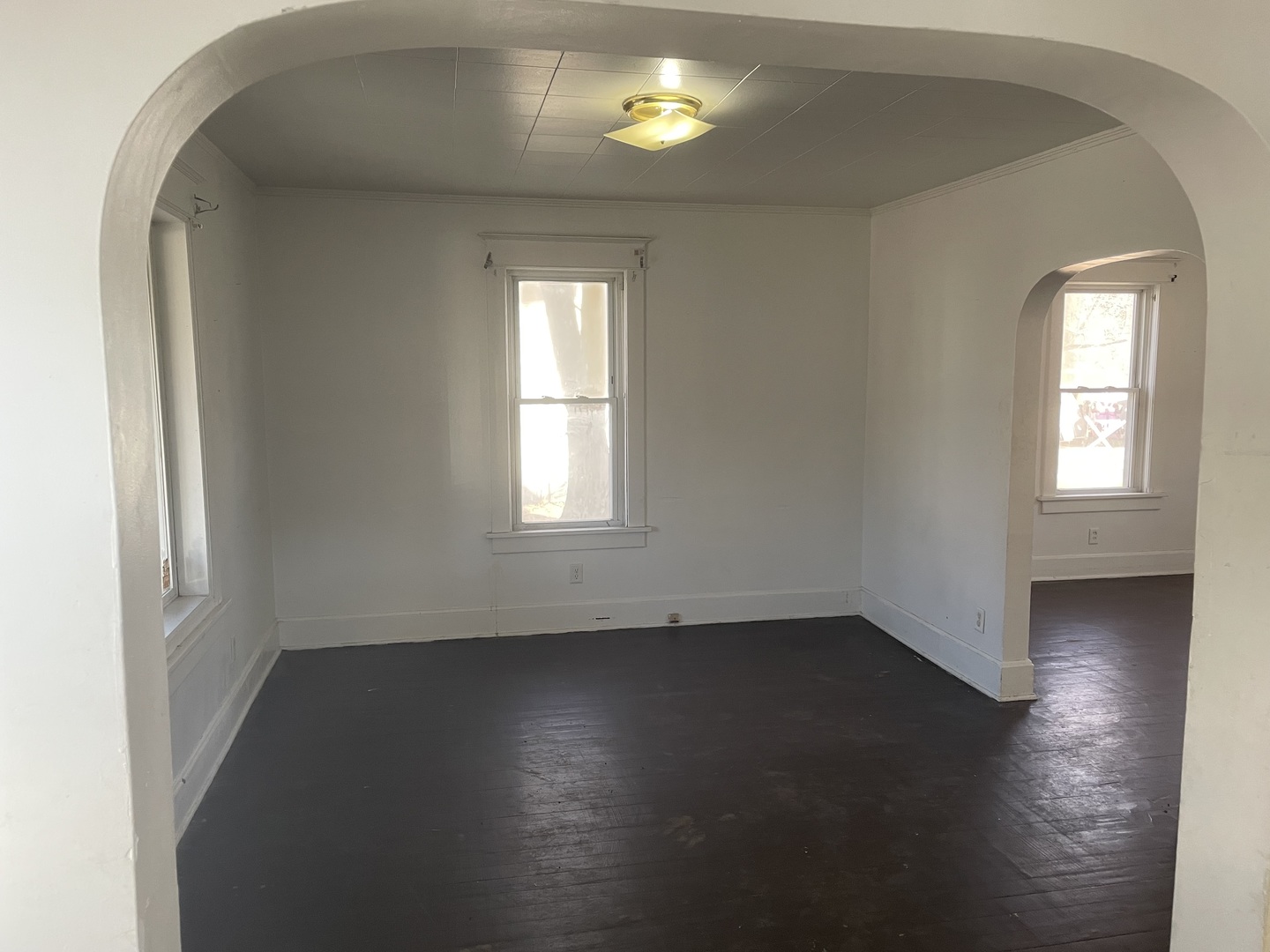3116 11th Avenue Moline, IL 61265 - Photo 2 of 10 an empty room with wooden floor and windows