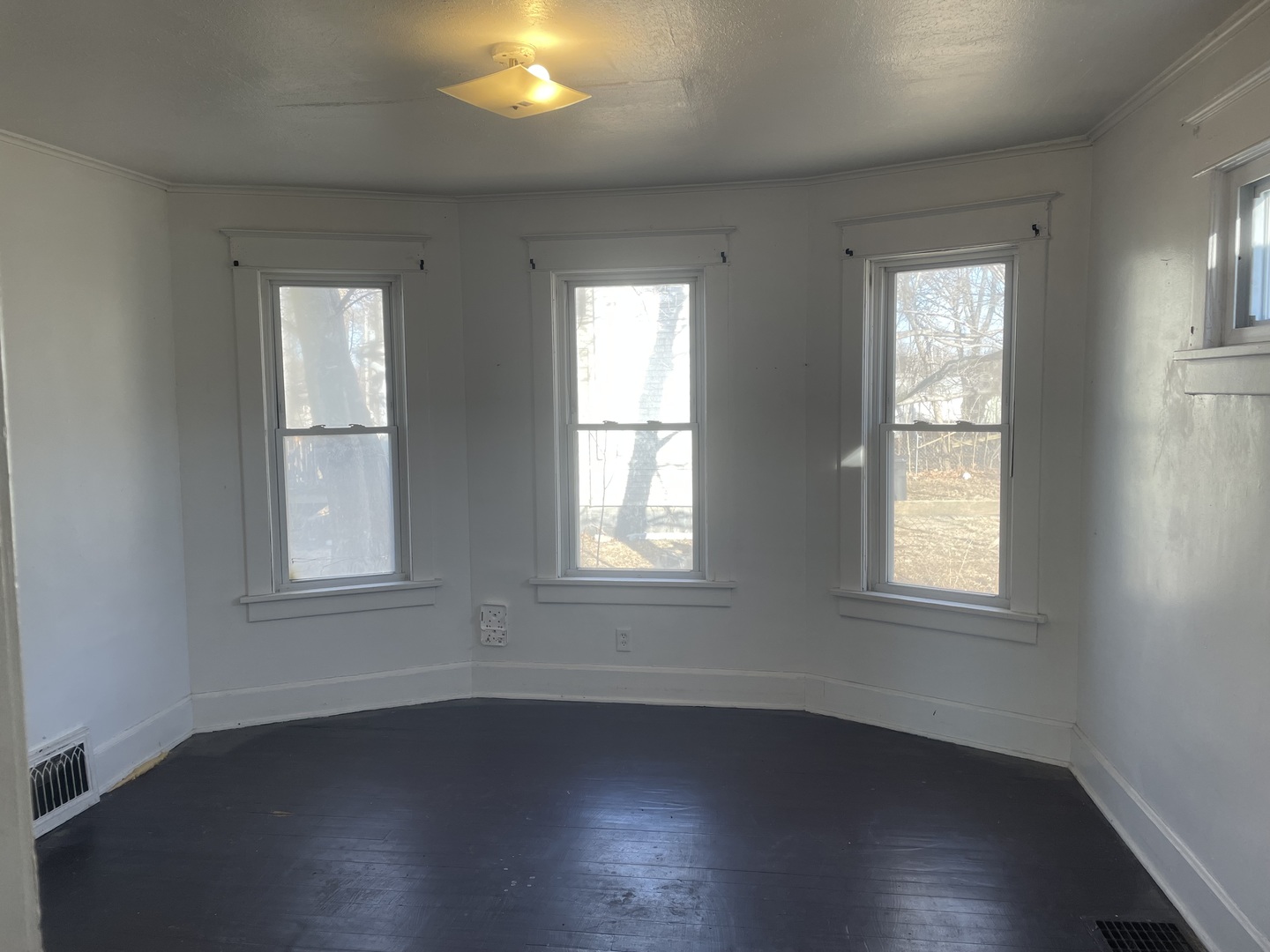 3116 11th Avenue Moline, IL 61265 - Photo 3 of 10 an empty room with wooden floors and windows