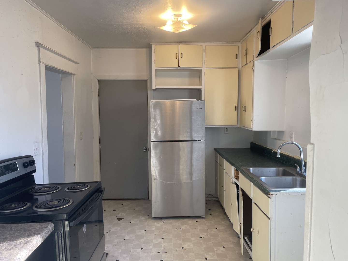 3116 11th Avenue Moline, IL 61265 - Photo 5 of 10 a kitchen with stainless steel appliances granite countertop a refrigerator a stove and a sink