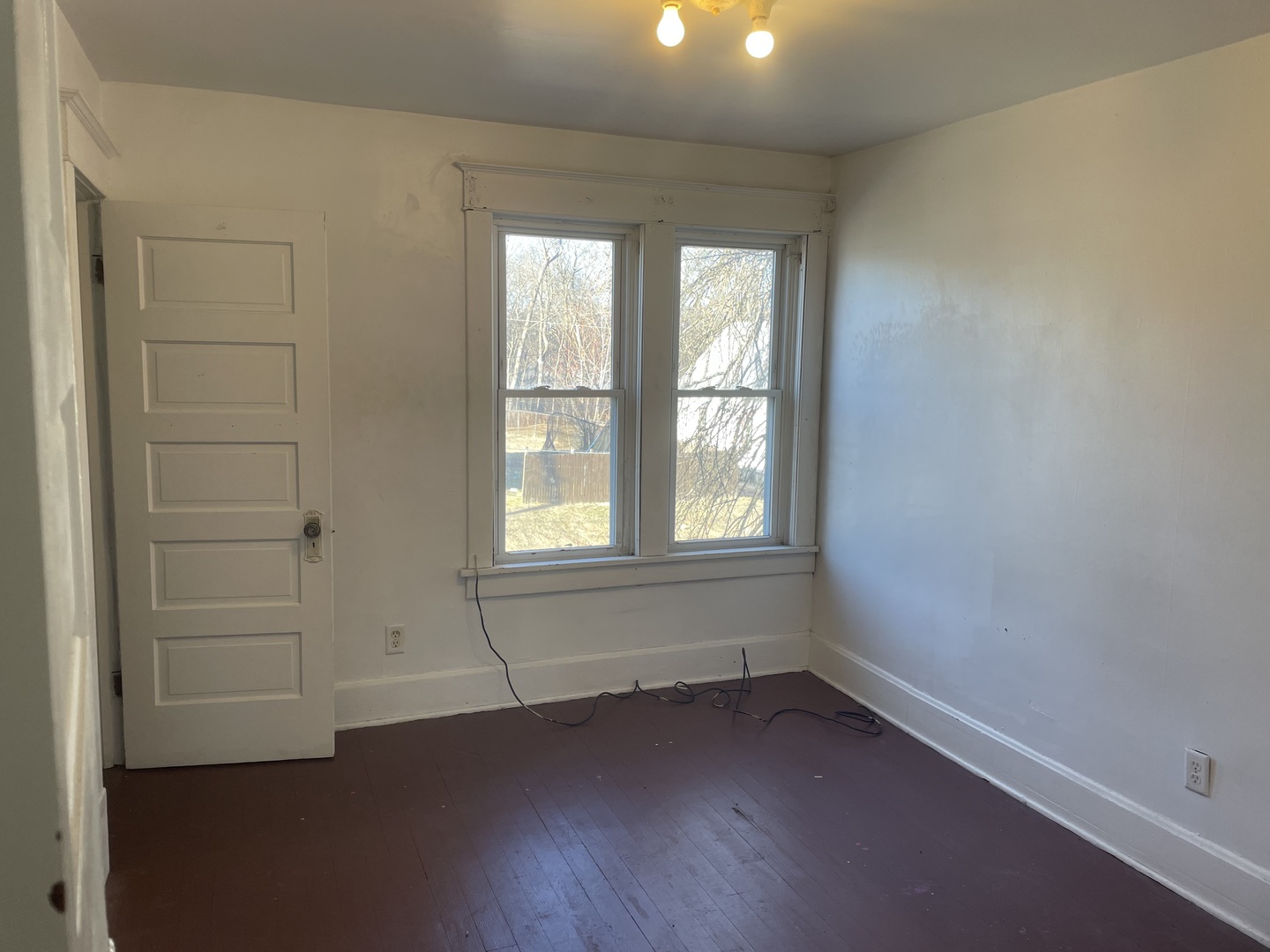 3116 11th Avenue Moline, IL 61265 - Photo 6 of 10 an empty room with wooden floor and windows