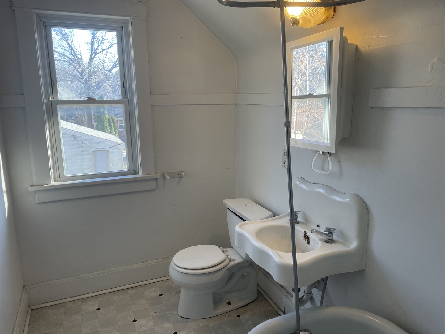 3116 11th Avenue Moline, IL 61265 - Photo 9 of 10 a white toilet sitting next to a bathroom sink