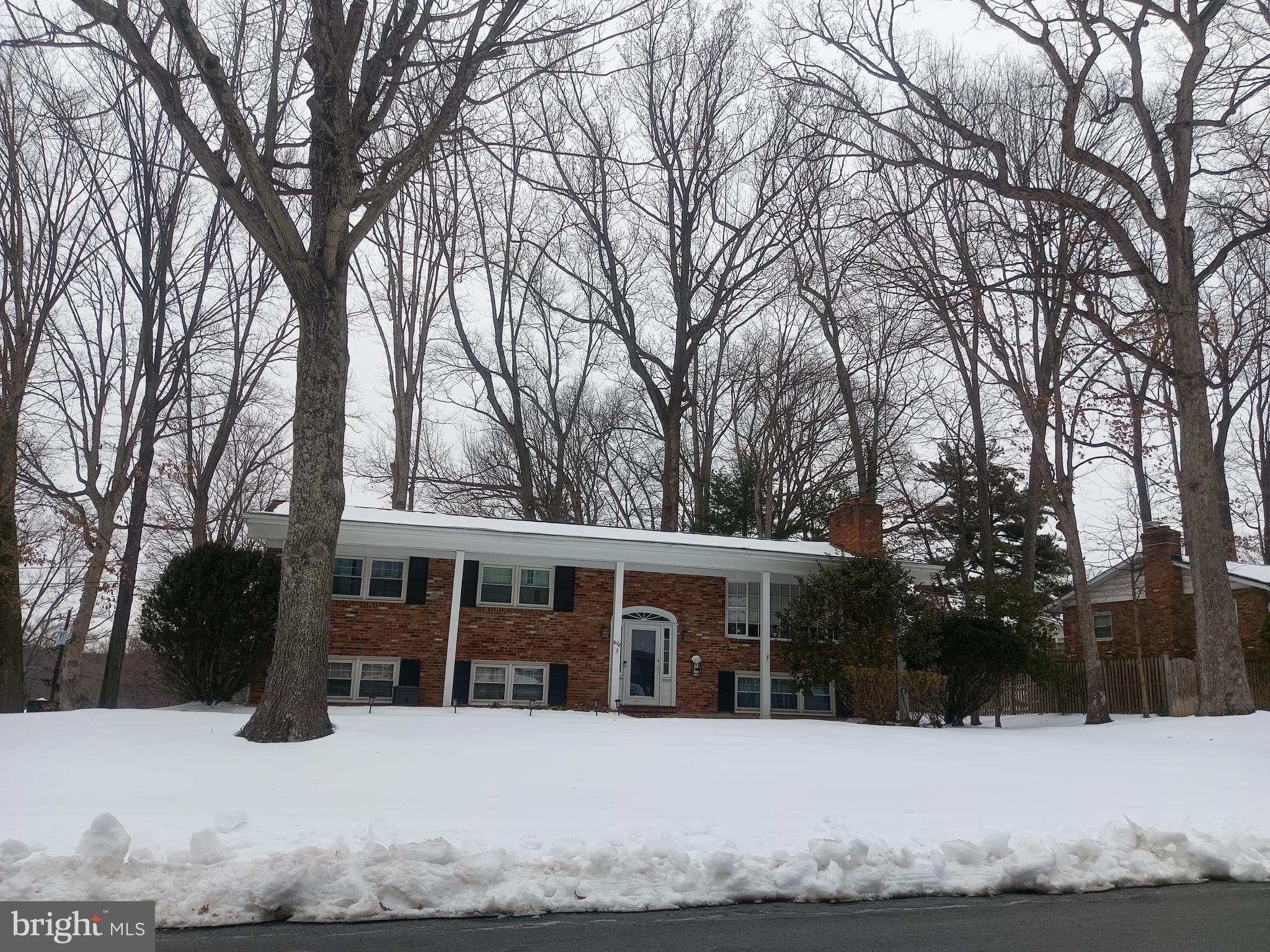 9128 Glenbrook Road Fairfax, VA 22031 - Photo 2 of 3 a view of house with a yard covered in snow