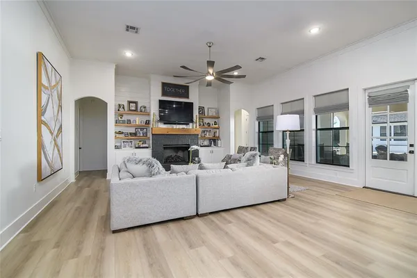 a living room with furniture a fireplace and a flat screen tv