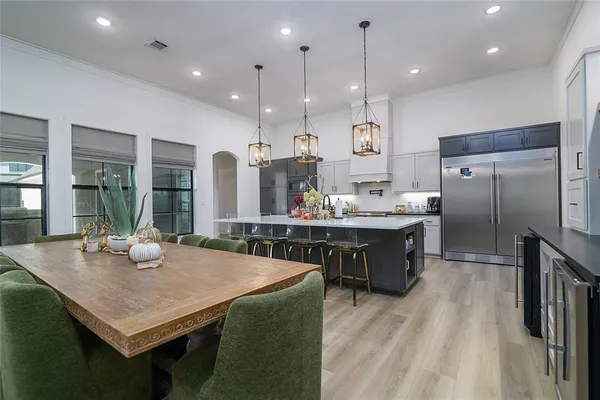 a kitchen with kitchen island stainless steel appliances a sink stove and refrigerator