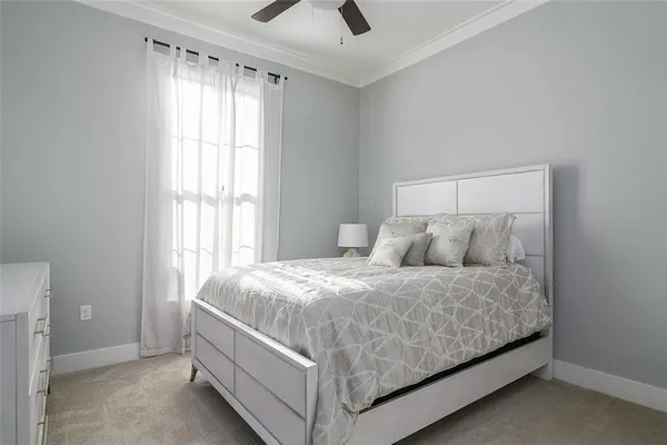 a bed sitting in a bedroom next to a window