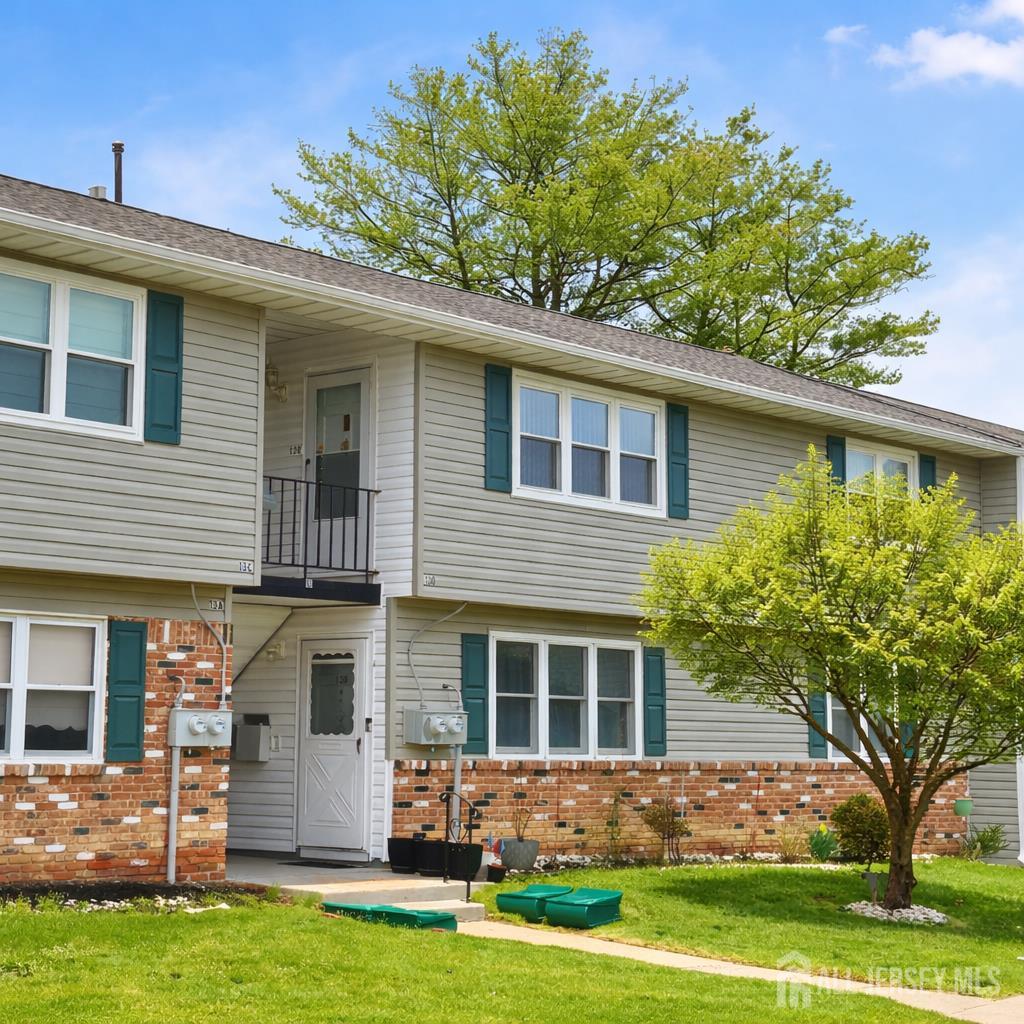 13 Delaware Court, Unit D Matawan, NJ 07747 - Photo 1 of 1 a front view of a house with garden