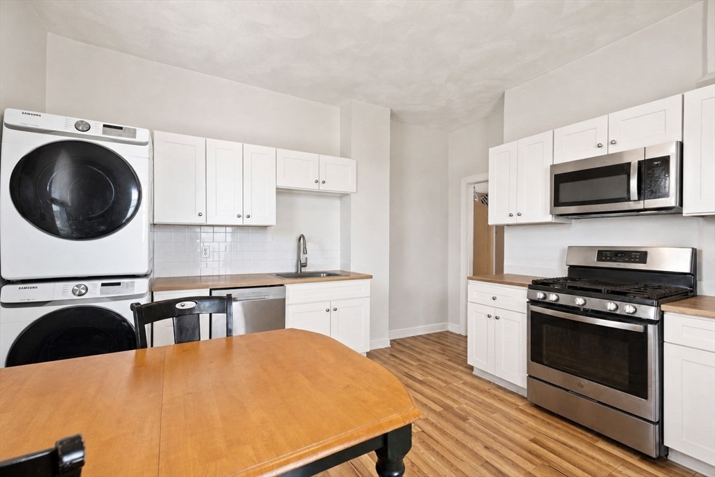 39 Union Street Boston, MA 02135 - Photo 20 of 33 a kitchen with a stove a sink and a microwave