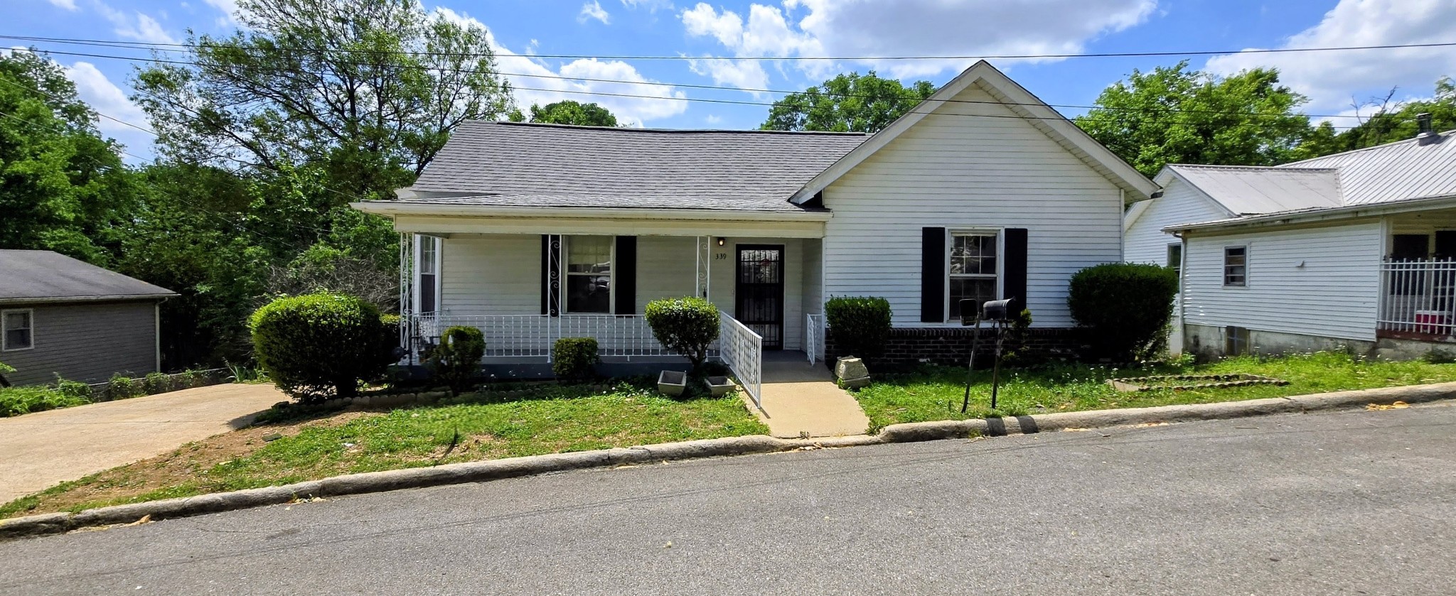 339 West Washington Street Pulaski, TN 38478 - Photo 1 of 23 a front view of a house with a yard and potted plants