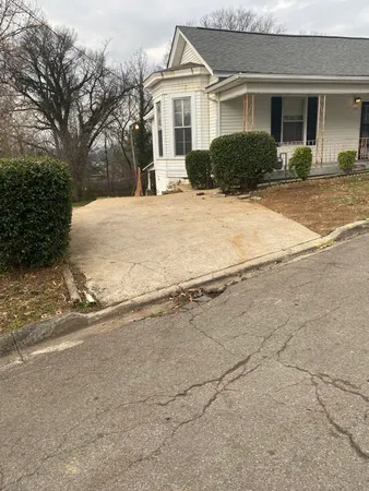 a front view of house with yard and trees around