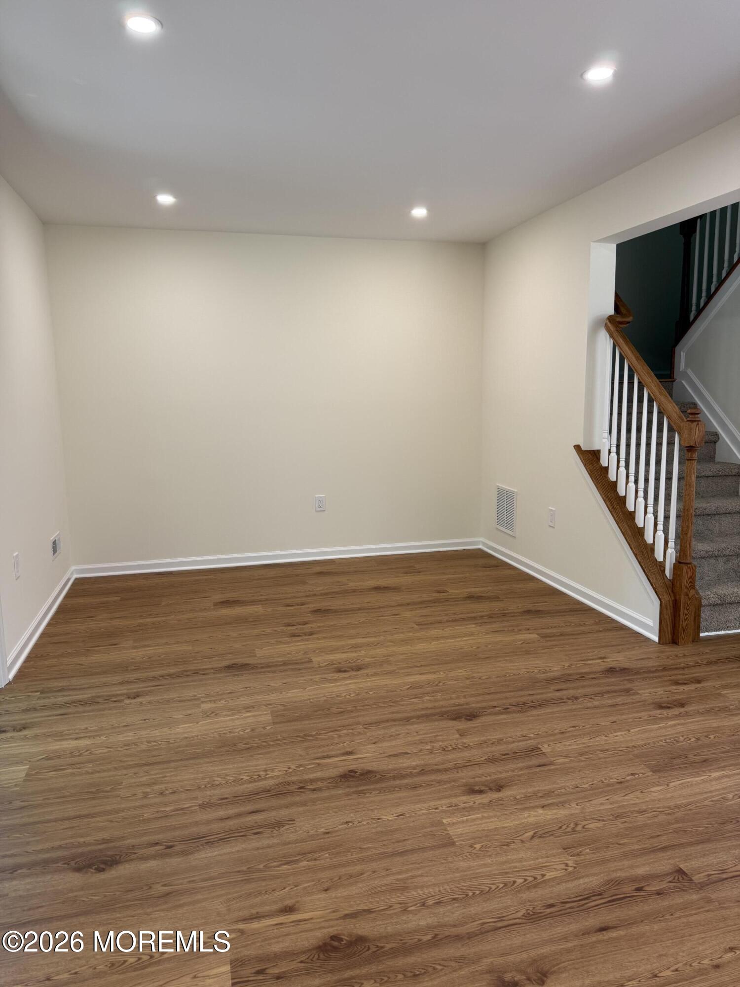 5 Canary Circle Howell, NJ 07731 - Photo 9 of 32 an empty room with wooden floor and windows