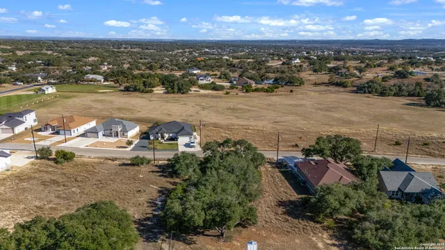 an aerial view of a house with a lake view
