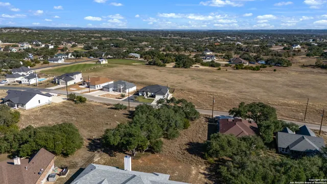 an aerial view of a house with a yard