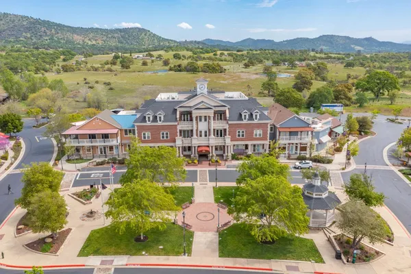 an aerial view of a house with a swimming pool yard and lake view