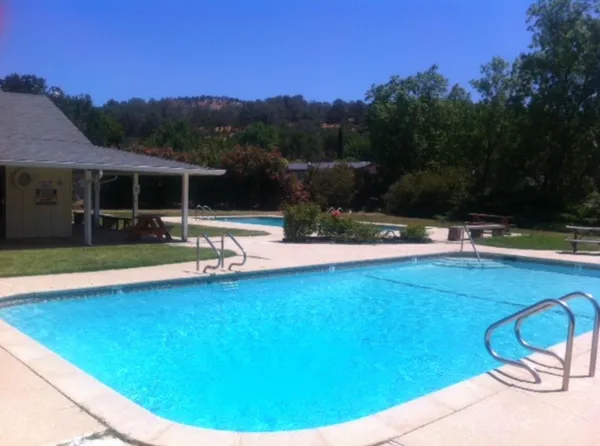 a view of a swimming pool and a yard