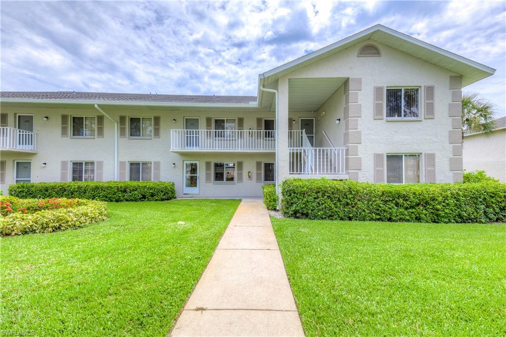 760 Augusta Boulevard, Unit D204 Naples, FL 34113 - Photo 1 of 32 a front view of a house with a yard