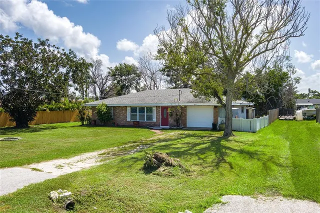 a yellow house in middle of green field