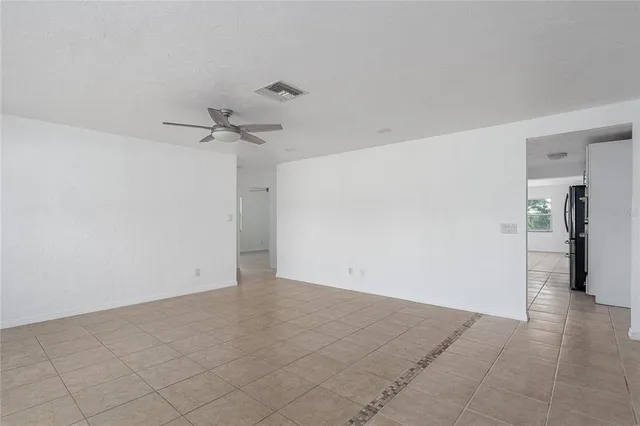 a view of a room with a ceiling fan