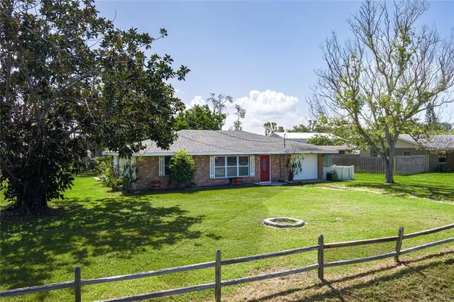 a view of a house with pool and a yard