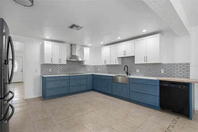 a kitchen with stainless steel appliances granite countertop a sink and cabinets