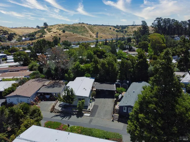 a kitchen with a dining table chairs wooden floor cabinets and appliances