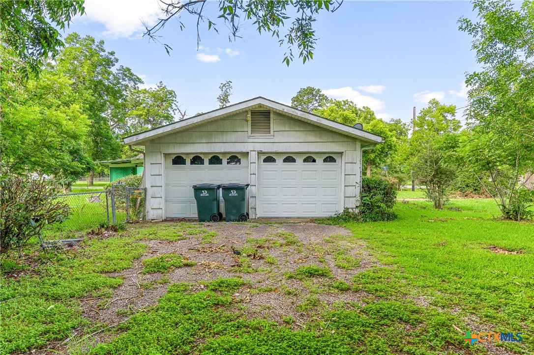 401 Kerr Street Edna, TX 77957 - Photo 5 of 23 a front view of a house with a yard