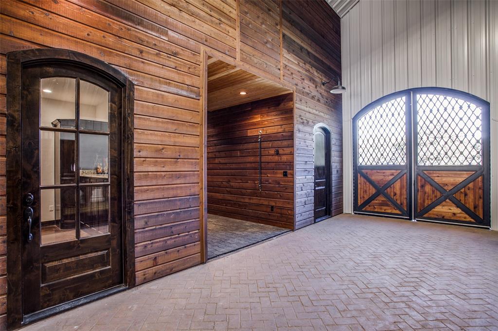 12630 Merrill Road Pilot Point, TX 76258 - Photo 20 of 39 Tack room, grooming stall and feed room. Details include Stamped brick concrete. Custom arched center isle breezeway doors.