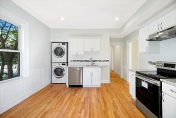 348 Centre Street, Unit 3 Boston, MA 02130 - Photo 13 of 17 a kitchen with a stove a sink and a refrigerator
