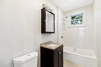 348 Centre Street, Unit 3 Boston, MA 02130 - Photo 14 of 17 a bathroom with a toilet sink and mirror