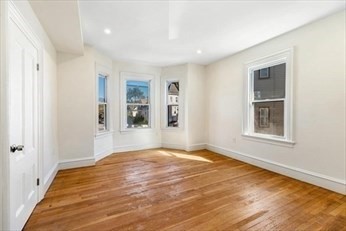 348 Centre Street, Unit 3 Boston, MA 02130 - Photo 2 of 17 a view of an empty room with window and hardwood floor