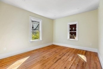 348 Centre Street, Unit 3 Boston, MA 02130 - Photo 5 of 17 a view of an empty room with wooden floor and a window