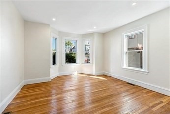 348 Centre Street, Unit 3 Boston, MA 02130 - Photo 6 of 17 a view of an empty room with wooden floor and a window