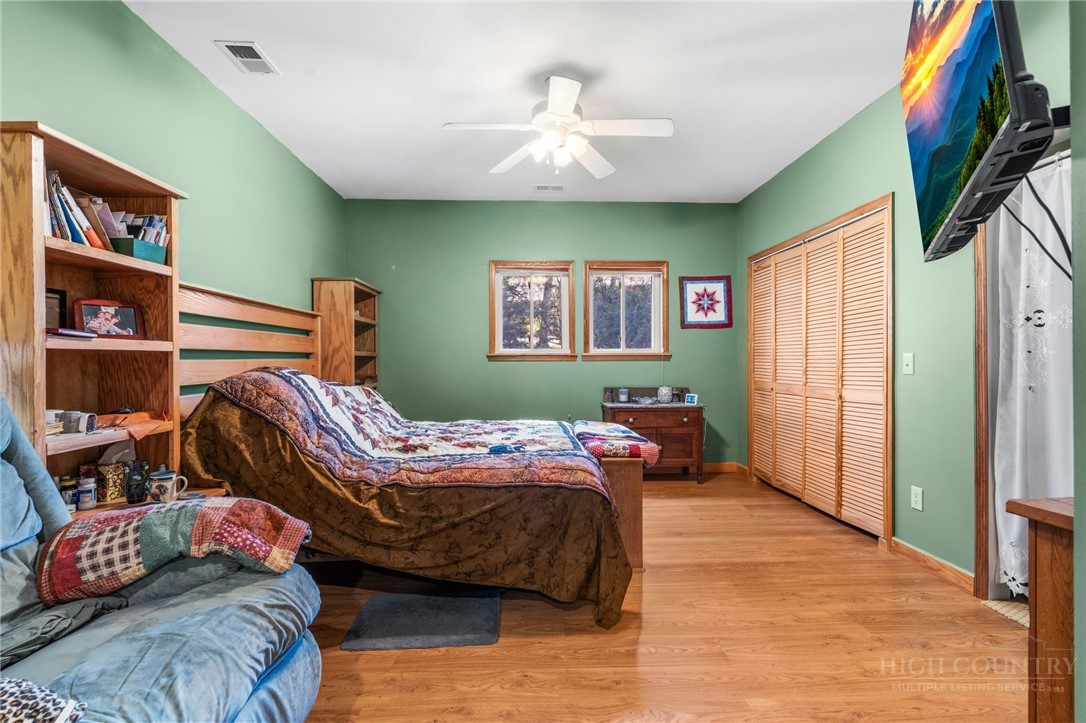 143 Lena Way Jefferson, NC 28640 - Photo 16 of 38 a bedroom with a bed and a bookshelf