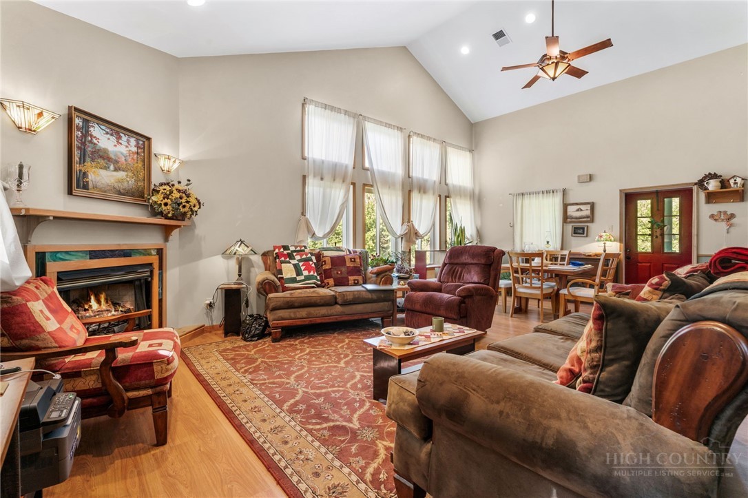 143 Lena Way Jefferson, NC 28640 - Photo 5 of 38 a living room with furniture fireplace and a large window