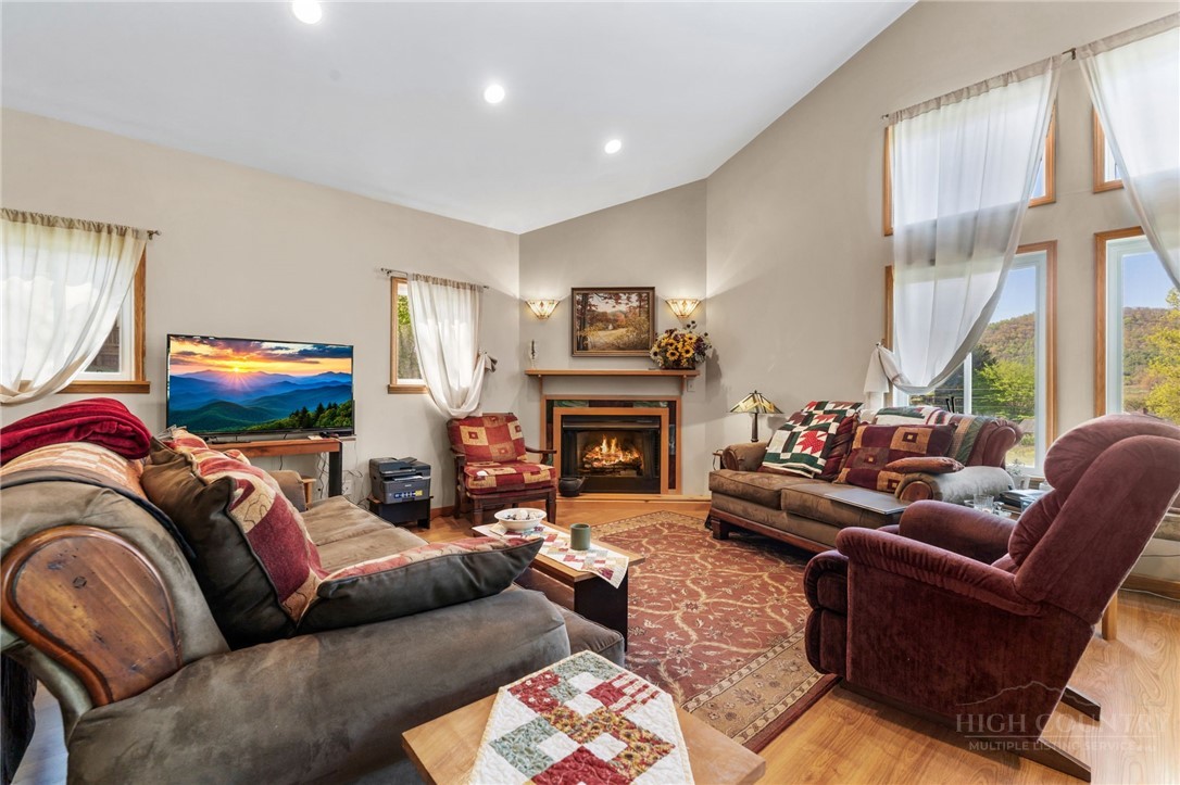 143 Lena Way Jefferson, NC 28640 - Photo 6 of 38 a living room with furniture a large window and a fireplace